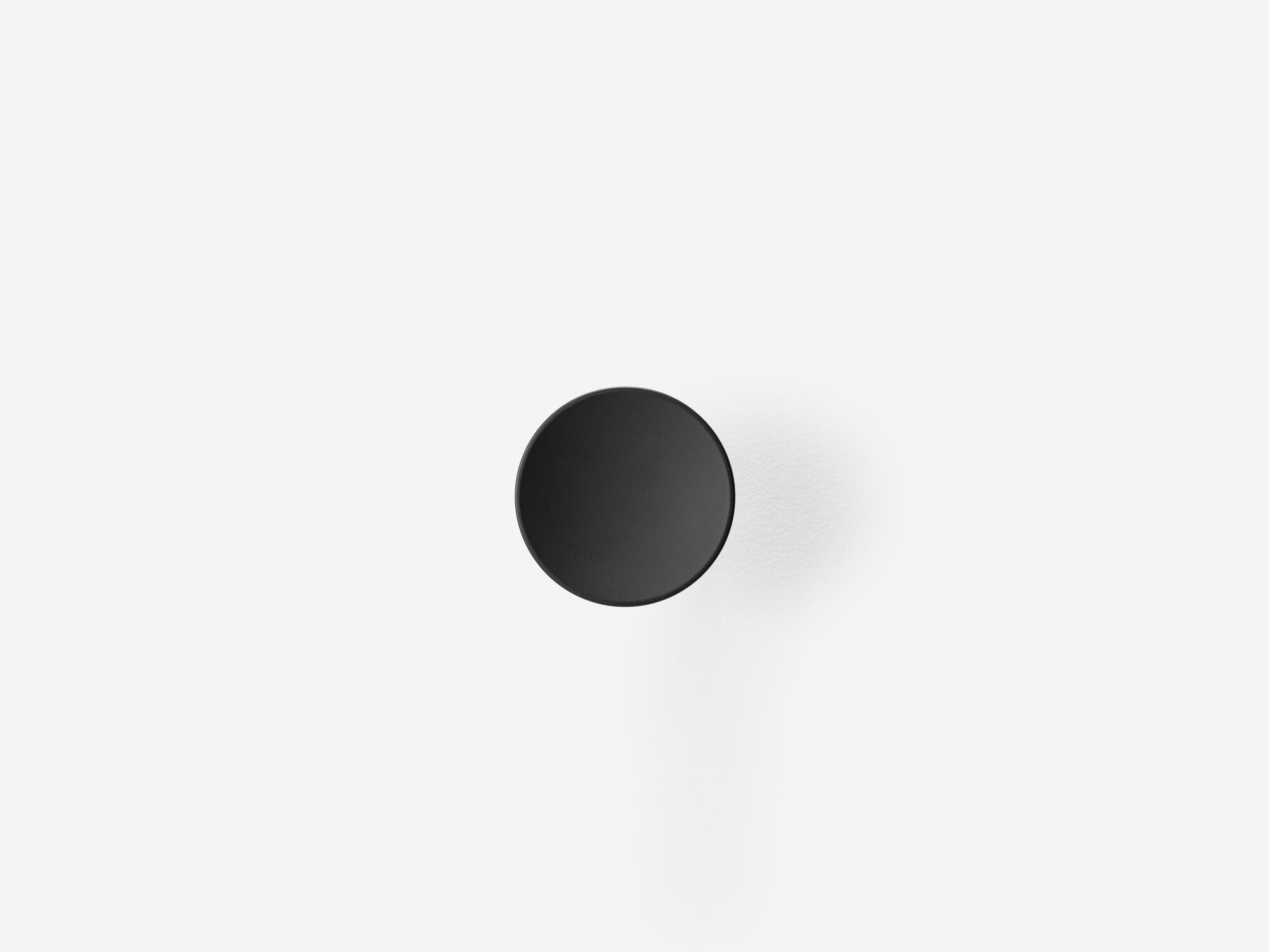 Medium black wall knob front view